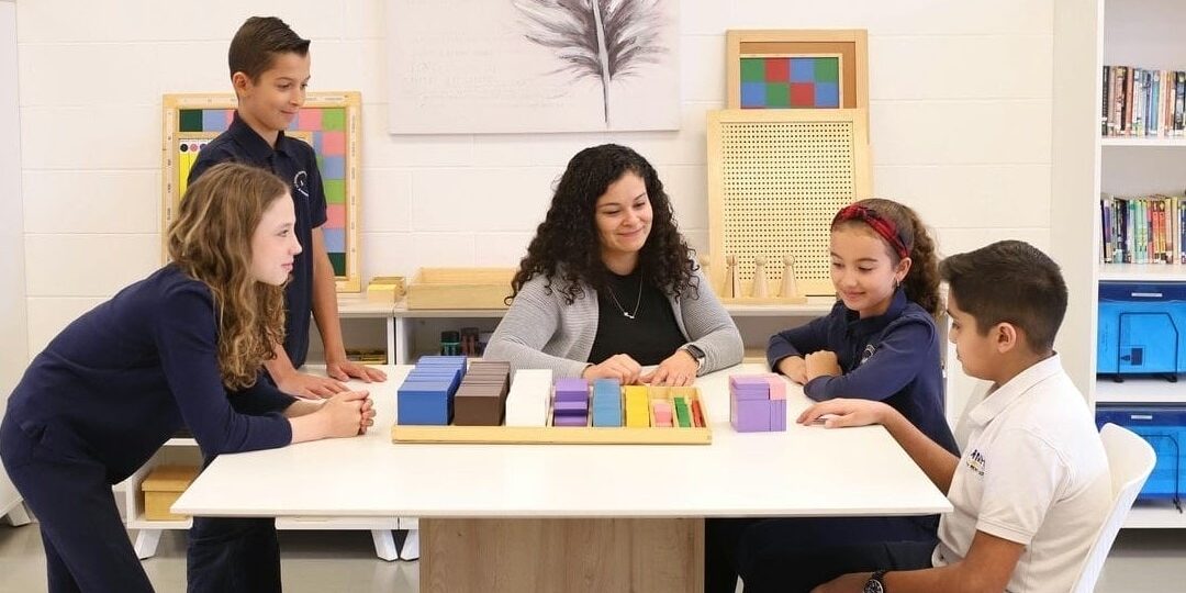 elementary montessori students learning with educator